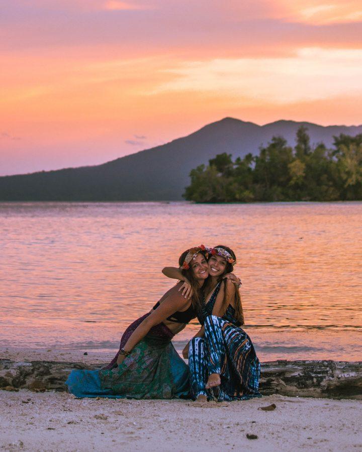 two bestfriends in flower crowns watching sunset in the Solomon Islands