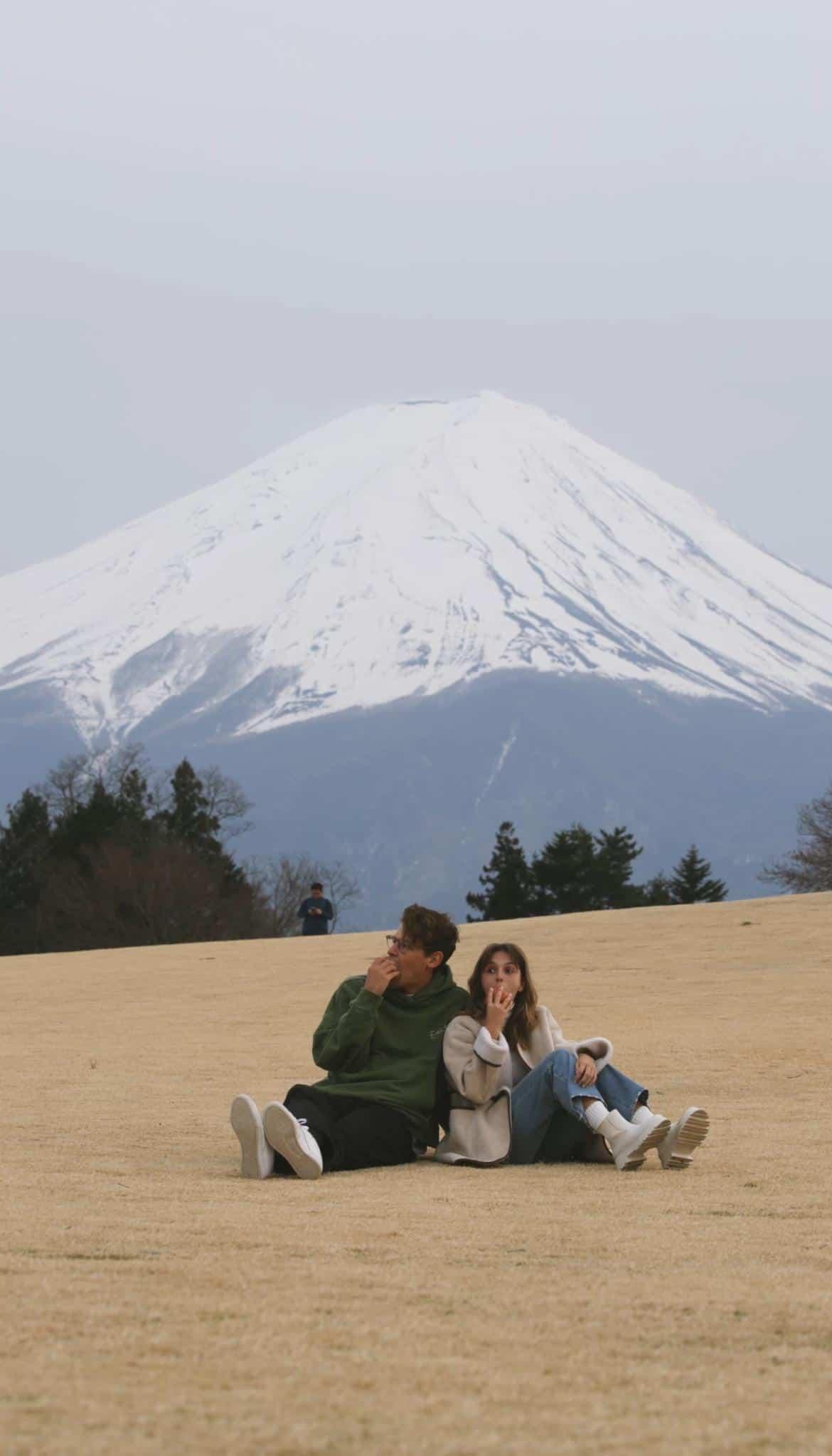 Couple having a fuji apple picnic with Mt Fuji in the background