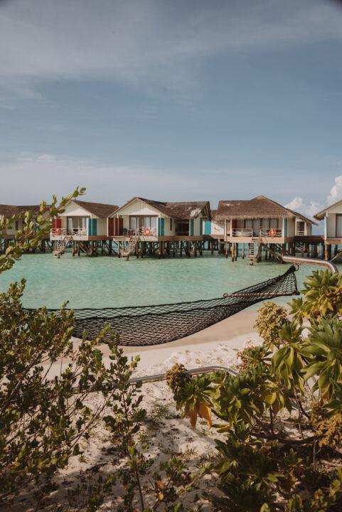Hammock on the beach at Cora Cora Maldives overlooking lagoon water villas