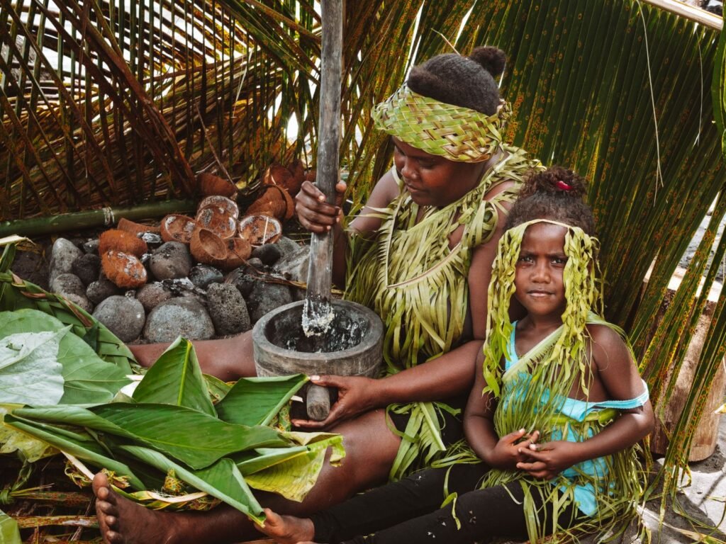 Things to do in the solomon islands: mum and daughter dreassed in traditional leaf outfits in a remote village on Rendova Island